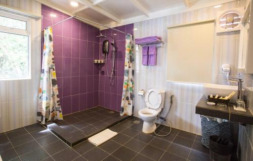 a purple bathroom with a shower and a toilet at Sutera Sanctuary Lodges At Manukan Island in Kota Kinabalu