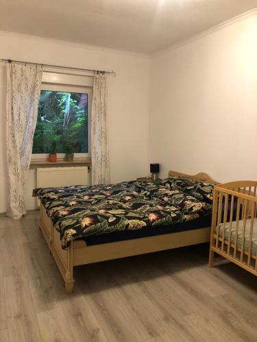 a bedroom with a bed and a window at Apartament Cozy Studio in Żagań