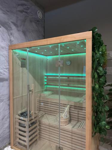 a glass shower with blue lights in a room at BREATH47SPA - Private Spa Suite White Jacuzzi & Sauna in Marbella in Marbella