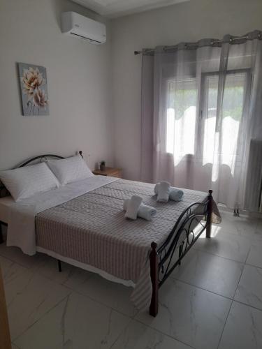 a bedroom with a bed with two towels on it at Meteora view Guesthouse in Kalabaka