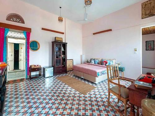 a bedroom with a bed and a table in a room at DanCenter Kolpol by CheckIn Udaipur in Udaipur