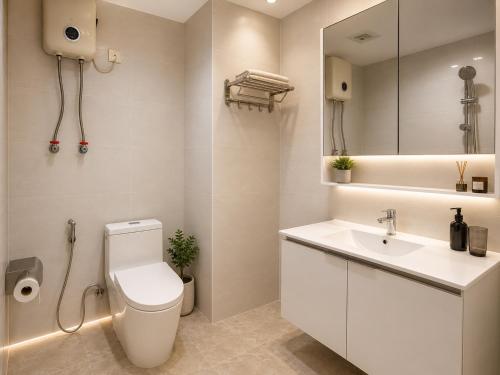 a bathroom with a toilet and a sink and a mirror at Tian Yue Hotel in Phnom Penh