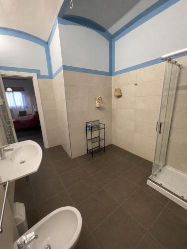 a bathroom with a shower and a toilet and a sink at Riolo Terme Camere in Riolo Terme