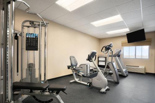 a gym with treadmills and elliptical machines at Baymont Inn & Suites by Wyndham Odessa in Odessa