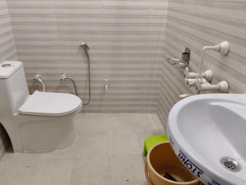 a bathroom with a toilet and a sink at NestIN hotels in Lucknow