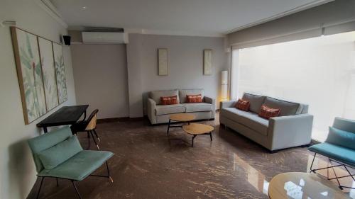 a living room with a couch and chairs and a table at BLUESEA Faro Cullera in Cullera
