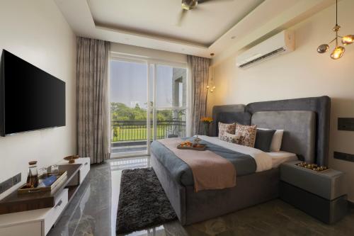 a bedroom with a large bed and a large window at Saffronstays Olive Farms in Mandkaula