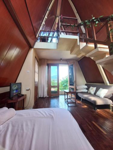 a large room with two beds and a couch at Agora Home in Wonosobo