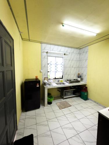a kitchen with a sink and a table in it at Triple A Kundasang in Ranau