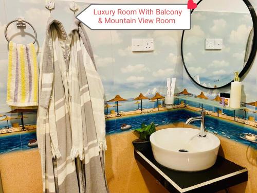 a bathroom with a sink and a mirror at Rock Face Palace in Ella