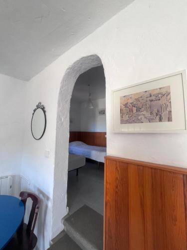 a room with a hallway with a bed and a picture at Montaña Las Tortolas in San Bartolomé