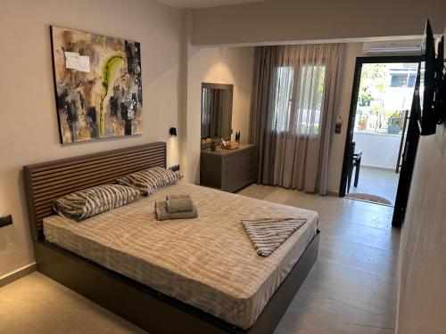a bedroom with a large bed and a bathroom at THE FLOWER APARTMENTS in Toroni