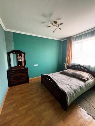 a bedroom with a bed and a ceiling fan at Дом твоей силы in Talghar