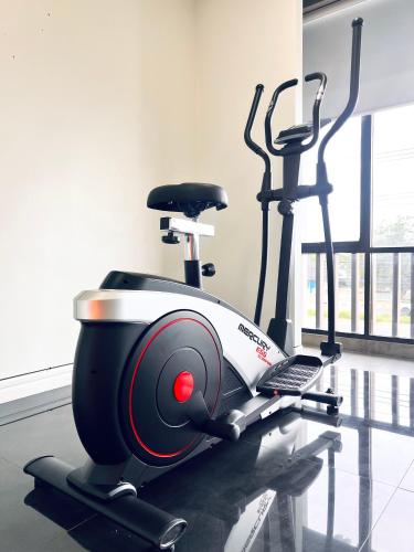 a gym with a treadmill and a exercise bike at LECAR Home Mustang in Ban Nong Khang