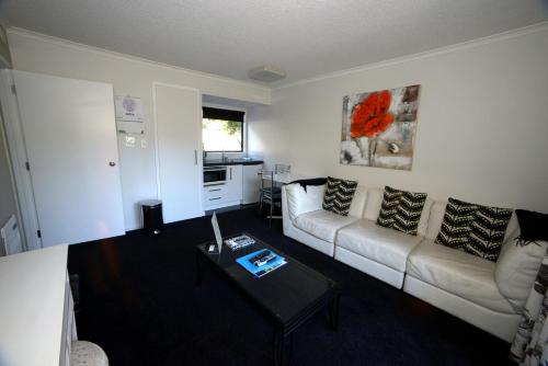 a living room with a couch and a table at Akaroa Village Inn in Akaroa