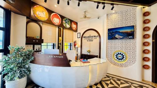an office with a reception desk in a building at Hotel Omkareshwar Jyotirling Inn in Godarpura