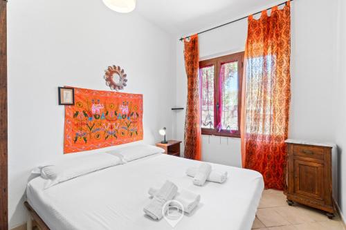 a bedroom with a white bed and a window at Estay - Zoe&Perla - Exclusive vacation near the beach in S'archittu Cuglieri