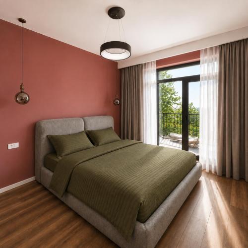 a bedroom with a large bed and a large window at Matilda Signature Apartments in Telavi