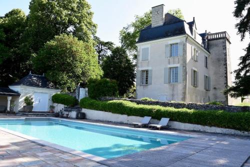 a swimming pool in front of a house at Château de Chavigny in Chambourg-sur-Indre