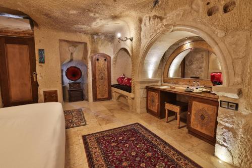 a bathroom with a sink and a vanity in a building at Elika Cave Suites Cappadocia, Curio Collection by Hilton in Ortahisar