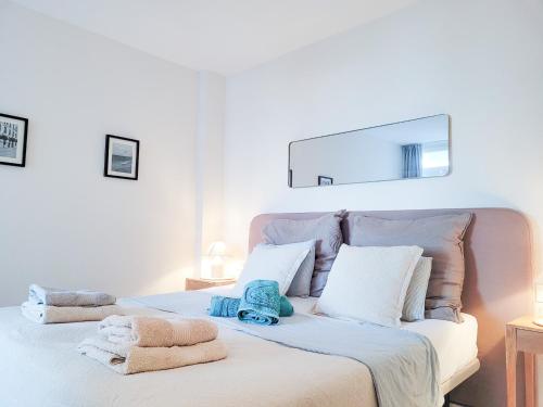 a bedroom with a bed with towels on it at Secret View Riviera Miraflores in La Cala de Mijas