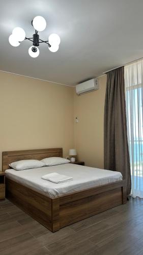a bedroom with a bed and a ceiling fan at Aqua Batumi 44 in Batumi