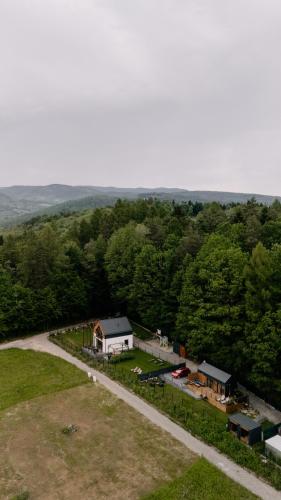 an aerial view of a farm with a house at Okno na Beskidy-domek LAS z balią , sauną i niesamowitym widokiem na góry in Maków Podhalański