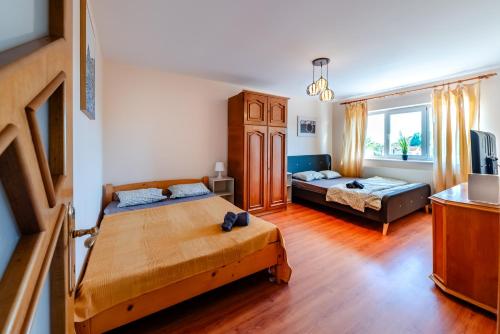 a bedroom with two beds and a living room at Walter Waves Private Apartment with Balcony and Self Check-In in Costinesti