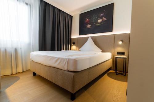 a bedroom with a large bed in a room at Hotel Sittardsberg in Duisburg