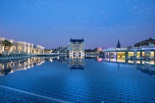 a large body of water with buildings and a building at Granada Luxury Belek - Family Kids Concept in Belek