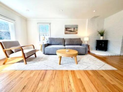 a living room with a blue couch and a table at Peaceful Redding Cottage Retreat in Redding