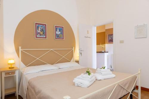a bedroom with a bed with towels on a table at Piccolo Paradiso - Montenero in Montenero