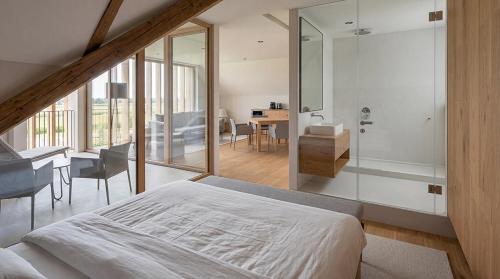 a bedroom with a bed and a table and a desk at Butični Hotel Sončno Polje in Moravske-Toplice