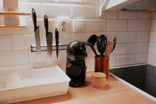 a kitchen counter with a knife holder and utensils at Apartment Slupečná Lipno in Kramolín