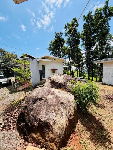 a large rock in front of a house at BIG INN Resort in Mattanūr