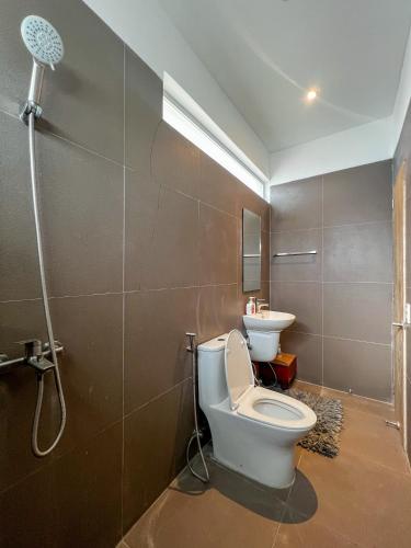 a bathroom with a toilet and a sink at The Hermitage Tagaytay-Junior Suite in Malabag