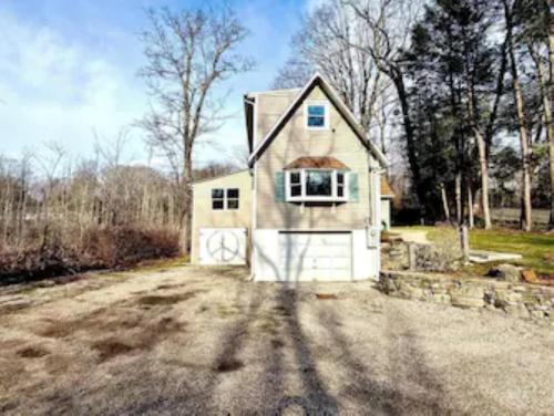 a small house with a garage on a dirt road at Peaceful Redding Cottage Retreat in Redding