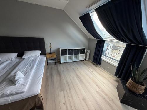 a bedroom with a large bed and a large window at Bodø Hotel in Bodø