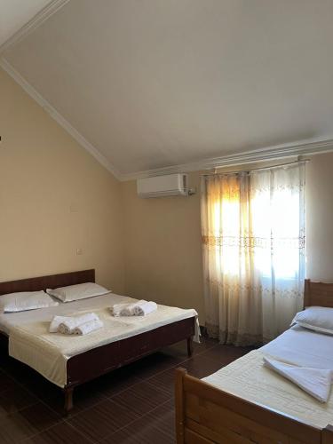 a bedroom with two beds and a window at Liza's house - Block B in Ureki