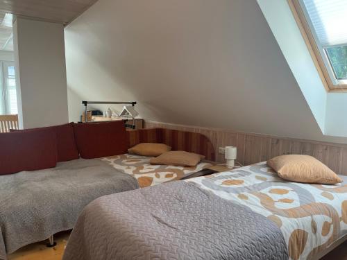 a bedroom with two beds in a attic at Männi hoovimaja in Pärnu