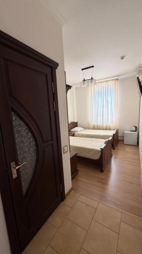 a room with a door leading to a bedroom with a bed at Motel in Sarny