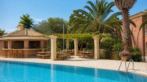 a resort with a swimming pool and a restaurant at Bright 2BR Apt Kitchenette Pool 3 in Gouvia