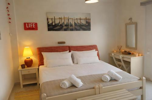 a bedroom with a bed with towels on it at Studio Gouvia Kitchenette Pool 8 in Gouvia