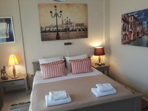 a bedroom with a large bed with two pillows at Studio Gouvia Kitchenette Pool 5 in Gouvia