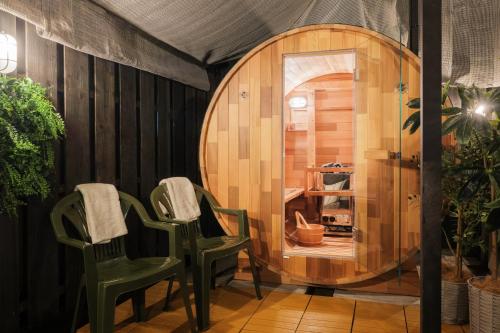 two green chairs in a room with a barrel at SNUGGLE2222 Odawara Nakacho in Odawara