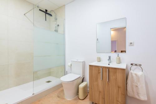 a bathroom with a toilet and a sink and a shower at Almenara in Almenara