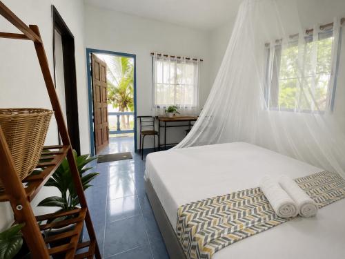 a bedroom with a bed with a mosquito net at Secret Place Hotel and Restaurant in Haad Yao