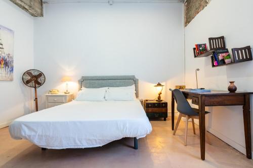 a bedroom with a bed and a desk and a desk at Almenara in Almenara