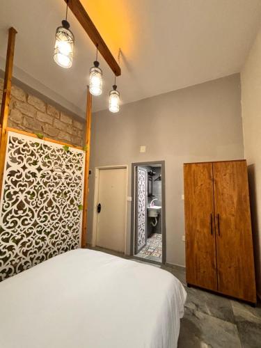 a bedroom with a white bed and a mirror at Diamond Studio Apartment - Haifa in Haifa