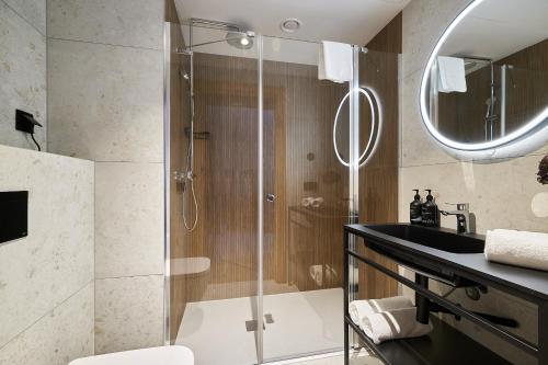 a bathroom with a shower and a sink at Harmony Valley Resort in Szklarska Poręba